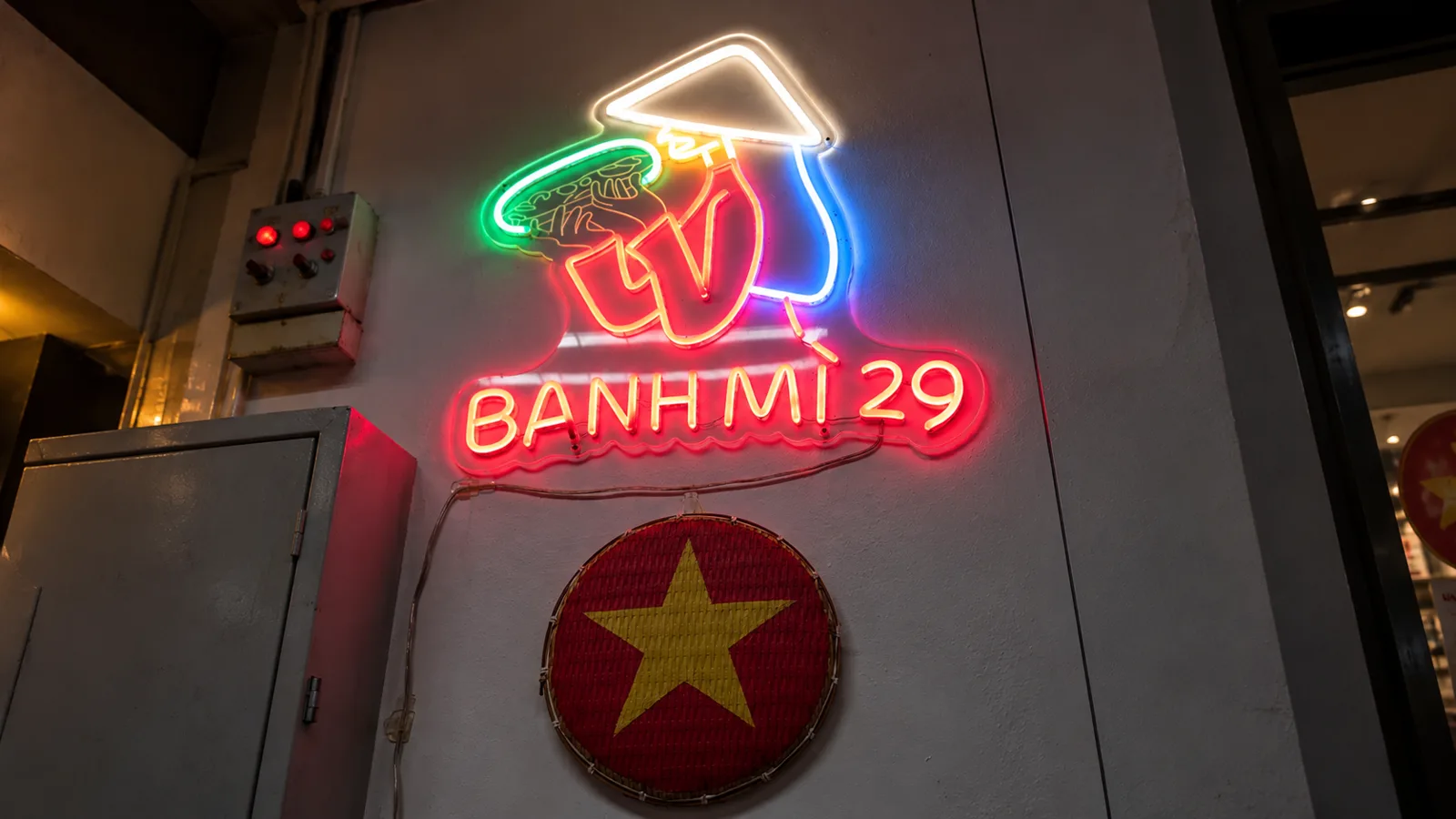 Inside Bánh Mì 29 under its neon sign